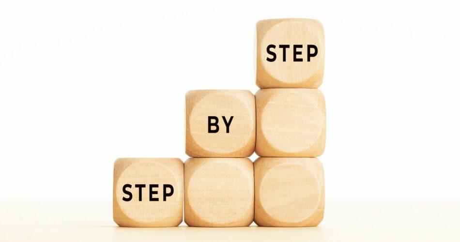 Step by Step phrase on wooden block shape