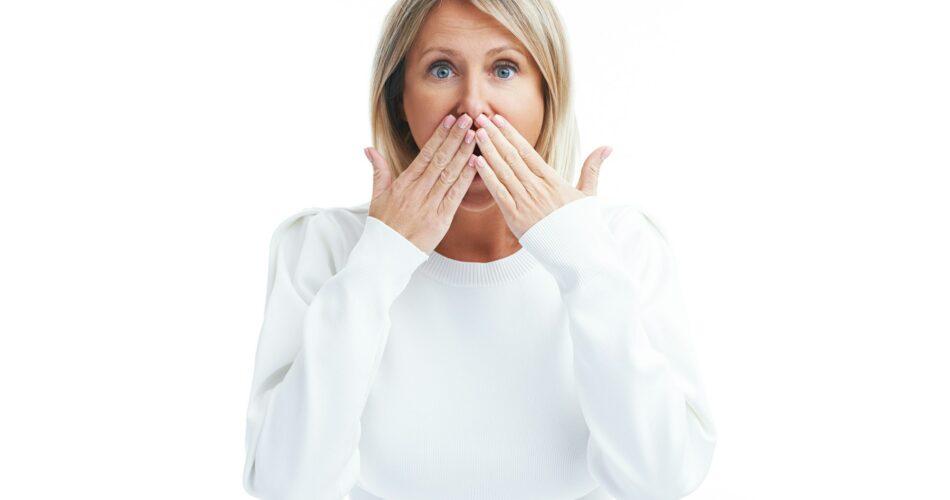 Picture of suprised blonde woman isolated over white background